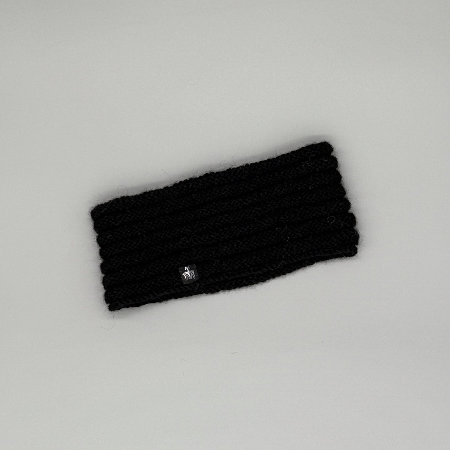Alpaka Stirnband aus 100% Baby Alpaka in Schwarz mit Röllchenmuster – extra warm und weich.